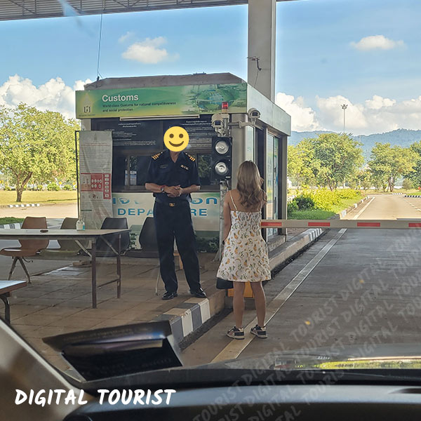 Lady talking to Thai Immigration about crossing to Huay Xai in a car